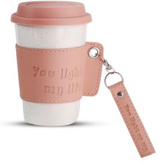 a pink leather keychain with a coffee cup on it and the words, you might