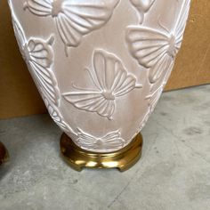 a white vase sitting on top of a table