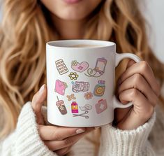 a woman is holding a coffee mug with different things on it