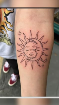 a woman's arm with a sun and moon tattoo on the left side of her leg