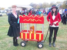 two women standing next to each other in front of a cart