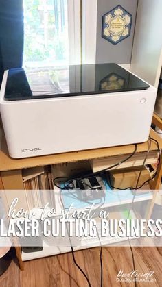 a white printer sitting on top of a wooden table