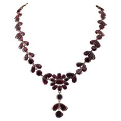 Red Garnet Love Antique Georgian period, 1800 ca, beautiful necklace made during the time of solid 9 Kt gold Comprising a riviere necklace with a centrepiece in the shape of a flower with suspended finial, close back setting as for Georgian tradition, with approx 53.00 Ct of natural Almandine Garnets flat cut, firey and sparkly Necklace is 43 cm in length, clasp is 15 x 17 mm. – central is 27 x 55 mm. (h. x w.) Very good condition keeping with age Georgian Garnet jewellery is rare and collectabl Gold Garnet Gemstone Necklace, Silver Pendant Necklace Georgian, Georgian Necklace, Luxury Yellow Gold Garnet Necklaces, Vintage Red Garnet Necklace, Sparkly Necklace, Hermes Kelly Bag, Almandine Garnet, Garnet And Gold