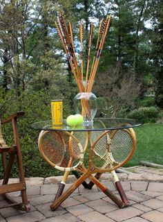 a glass table topped with tennis rackets and balls