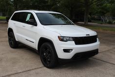 a white jeep parked in a parking lot