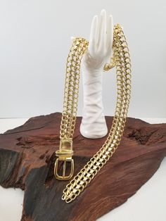 "Cool gold link belt. The belt fastens with a buckle and since it is chain you can buckle at whatever length you choose.  The base of the belt is gold links with gold metallic fabric woven through links. This belt would look great with an over-sized shirt, dress, t-shirt.  The belt measures between 43\" long 1\" 3/8 wide.  Just want to mention all my pieces are vintage I do not know the history of their life before me.  I inspect them all before posting them and let you know of any damage I see. Dress T Shirt, Gold Link, Metallic Fabric, Gold Fabric, Suspender Belt, Fabric Belt, Vintage Pieces, Vintage Accessories, Metal Chain