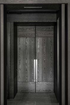 an empty room with wooden walls and doors