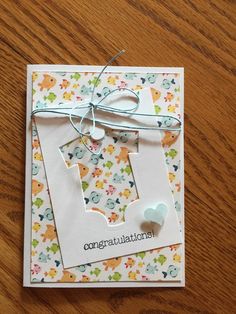 a greeting card with congratulations written on the front, and a tag attached to it