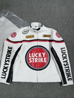 🔥 Vintage Lucky Strike Leather Jacket 🔥 Step back in time with our Vintage Lucky Strike Leather Jacket! 🕰️✨ This iconic piece is a perfect blend of classic style and rugged durability. 💪🧥 Crafted from premium full-grain leather, it promises not only a unique look but also unmatched longevity. 🛠️🕶️ The jacket features: A rich, deep patina that only comes with age, giving each piece a one-of-a-kind charm. 🎨✨ Sturdy zippers and snap buttons for a secure fit. 🔒🧲 Multiple pockets for all your essentials. 🗝️📱 A comfortable, well-worn feel that makes it perfect for any occasion. 🌟👕 Whether you're hitting the open road 🛣️🏍️ or just want to add a touch of vintage cool to your wardrobe, this Lucky Strike jacket is the ultimate choice! 🎯💼 Don't miss out on owning a piece of fashion Retro White Biker Jacket For Winter, Retro White Biker Jacket For Fall, Classic Hooded Leather Jacket, White Winter Outerwear For Biker Events, White Outerwear For Biker Events In Fall, White Fall Outerwear For Biker Events, Classic White Leather Jacket With Long Sleeves, Classic White Long Sleeve Leather Jacket, Casual White Motorcycle Outerwear