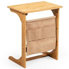 a wooden table with a magazine rack on it's side and a seat attached to the back