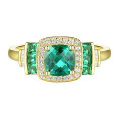 an emerald and diamond ring set in yellow gold