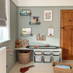 a child's playroom with toys and storage bins