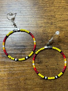 Navajo pattern round hoop dangle earrings. Made with multicolored glass seed beads attached to a hypoallergenic earring ring fixing. Adjustable Hoop Earrings With Dangling Beads, Adjustable Circular Beaded Jewelry, Nickel Free Multicolor Beaded Round Earrings, Southwestern Beaded Round Earrings, Southwestern Round Beaded Earrings, Southwestern Style Beaded Round Earrings, Adjustable Colorful Beaded Round Earrings, Adjustable Round Earrings With Colorful Beads, Adjustable Colorful Beaded Circle Hoop Earrings