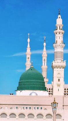 a large white building with two green domes