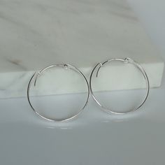 These are big sterling silver hoops, with a flat surface. Dimensions: 4 X 35 mm Weight: 5.2 gm These earrings are made of 925 hypoallergenic sterling silver. All my pieces are sent in a gift box. I can include a personal message from you if needed. You are welcome to contact me at... bhavnakwintra1956@gmail.com More Silver Hoops: https://www.etsy.com/your/shops/TheSilverGame/tools/listings/section:26305414 More Silver Earrings: https://www.etsy.com/your/shops/TheSilverGame/tools/listings/section Simple Sterling Silver Hoop Earrings, Minimalist Nickel-free Silver Hoop Earrings, Minimalist Small Hoop Earrings In Metal, Modern Silver Hoop Earrings With Simple Design, Silver Sterling Hoop Earrings With Simple Design, Minimalist Silver Metal Hoop Earrings, Minimalist Small Hoop Clip-on Earrings, Sterling Silver Hoop Earrings With Simple Design, Minimalist Small Hoop Metal Earrings