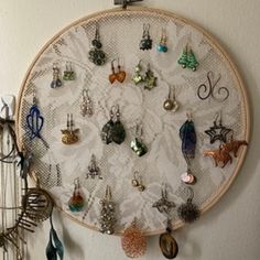 a wall hanging with various earrings on it