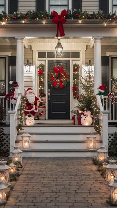 christmas decorations on the front steps of a house with lights and wreaths around them