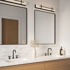 two bathroom sinks with mirrors above them in a white and wood colored room or office