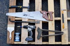 tools are laid out on top of pallets to be used in construction projects such as woodworking and painting