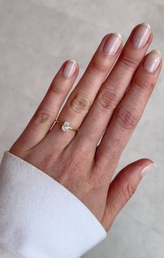 a woman's hand with a diamond ring on it