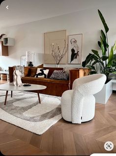 a living room filled with furniture and plants