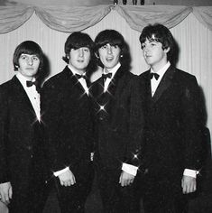 the beatles are posing for a photo in their tuxedo suits and bow ties