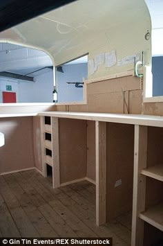 the inside of a boat with wooden shelves