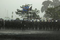 a large group of people standing in the rain