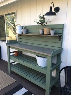 a potted plant sitting on top of a green bench next to a window and door