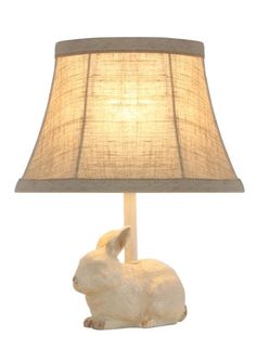 This little bunny lamp is perfect for a powder room, bedroom, or bookcase. Use it as a night light or accent light. The natural cotton/linen shade features a tan contrasting trim that accentuates the light brown accent on the bunny's paws, ears, and tail.  25-watt bulb not included.  12 H x 6 D x 9.5 W with lampshade Bunny Bedroom Decor, Joseph Bunny Lamp, Rabbit Lamp, Pottery Barn Bunny Lamp, Bunny Bookend, Bunny Lamp, Bunny Paws, Bird On Branch, Summer Kitchen