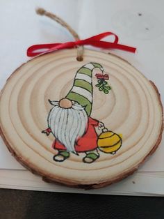 a wooden ornament with an image of a gnome on it