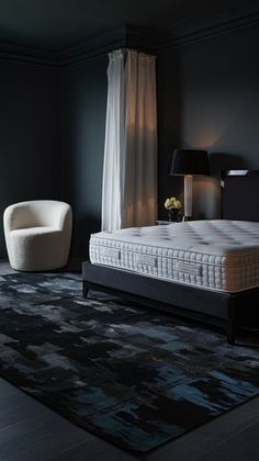 a white bed sitting on top of a black rug