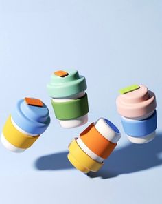 several colorful cups are arranged in the air