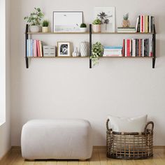 a living room with white walls and shelves filled with books