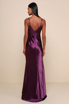 a woman in a purple dress looking back