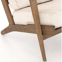 a wooden chair with a white cushion on it's back and armrests