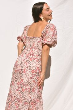 Sometimes you just need that everyday dress that's equal parts comfortable and cute. Our Dahlia Floral Maxi dress is cut from cotton pink, purple and mocha floral/paisley print fabric. Classic column dress silhouette with a button-down front, soft blouson sleeves and smocked back. You can wear the sleeves on or off the shoulders to give you a variety of different looks. This is the perfect bohemian dream dress! Spring Floral Print Mauve Dress, Mauve Floral Print Dress For Garden Party, Fitted Mauve Floral Print Dress, Mauve Floral Print Summer Dress, Mauve Floral Print Midi Dress, Pink Puff Sleeve Cotton Midi Dress, Pink Cotton Puff Sleeve Midi Dress, Spring Boho Print Cotton Midi Dress, Bohemian Paisley Print Daywear Dresses