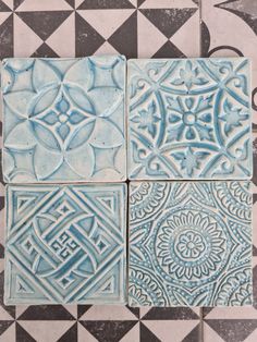 four blue and white tiles on the floor