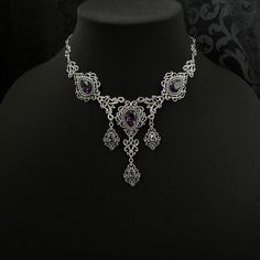 "This romantic necklace features richly detailed antiqued silver filigrees, scrolls and beaded accents. Adorned with sparkling dark amethyst purple glass crystals, its breath taking design will add Victorian elegance to your outfits. Decorated portion is 8 1/4\" wide and 2 3/4\" tall in the very center.  Necklace length is adjustable with soldered stainless steel cable chain, lobster clasp and extender. If you would like a different length, please send us a message. Matching headpiece and earrings are listed separately in our store. If you don't see items with a color you want, feel free to ask about availability." Rosary Chain Necklace, Purple Gothic, Antique Silver Necklace, Dark Amethyst, Romantic Necklace, Victorian Goth, Gothic Victorian, Costume Necklaces, Choker Pendant