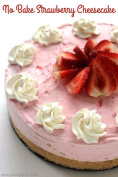 a strawberry cheesecake with whipped cream and strawberries on top