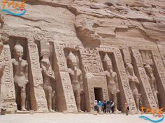 people standing in front of an ancient egyptian temple