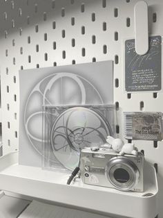 a camera sitting on top of a white shelf