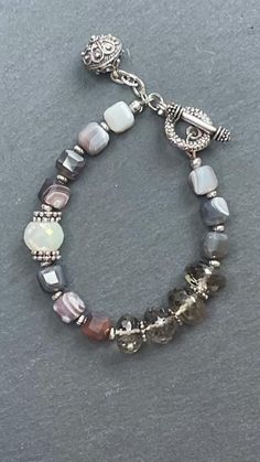 This bracelet is made of Botswana agate beads, smoky quartz, and with silver tone components. Cube Beads, Botswana Agate, Agate Bracelet, Agate Beads, Botswana, Smoky Quartz, Jewelry Ideas, Crystal Beads, Beaded Jewelry