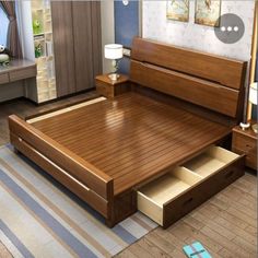 a wooden bed with drawers underneath it in a small room, next to a dresser