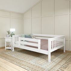 a white bed sitting on top of a wooden floor