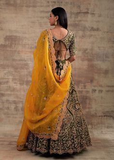 Choose a royal touch with this Pesto Green lehenga Shringarmati from Jannat Collection Are you struggling with the thought of what to wear on your special occasions? Look no further than this super-stylish pesto green color lehenga. This outfit is the game-changer that looks regal, royal and splendid. The most impressive thing about this lehenga is that it looks heritage, traditional and glamorous at the same time. Pepped up with Dori and gotta embroidery work, this lehenga will make you look li Transitional Tissue Silk Lehenga With Traditional Drape, Transitional Traditional Drape Tissue Silk Lehenga, Transitional Lehenga With Intricate Embroidery In Tissue Silk, Transitional Tissue Silk Lehenga With Intricate Embroidery, Reception Lehenga With Cutdana For Transitional Season, Cutdana Lehenga For Reception And Transitional Season, Transitional Reception Lehenga With Cutdana, Traditional Tissue Silk Lehenga, Semi-stitched Lehenga With Sheer Dupatta For Transitional Season