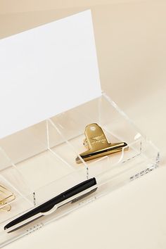 a pen and some other items in a clear box