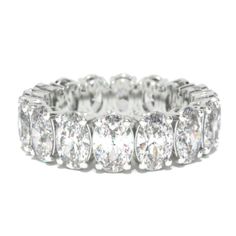 a white gold and diamond ring, with rows of diamonds on each side of the band