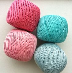 three balls of yarn sitting next to each other