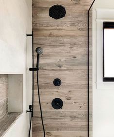 the shower head is mounted to the wooden wall